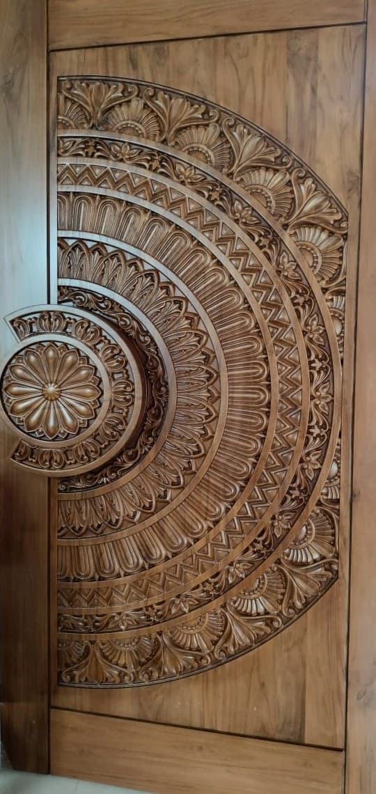 Hand-carved teak main door with a full mandala rosette motif