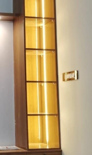 Backlit glass display column with LED-lit shelves, built into a floating TV unit